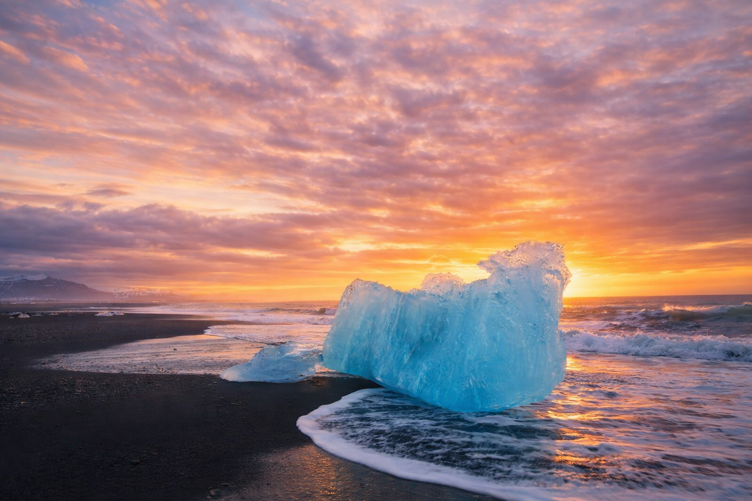Photographer at the lagoon shoreline capturing icebergs